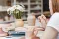 Clay pottery ceramic, woman decorating dishware pot