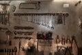 Workshop scene. Image of old tools hanging on wall in workshop. Vintage retro garage style