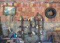 Workshop scene, interior wall of an old dirty garage full of stuff. Royalty Free Stock Photo