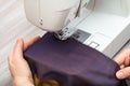 Designer sews bands of fabrics for patchwork