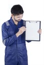 Workshop worker holds clipboard