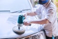 Workshop worker polishing the car