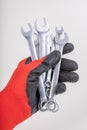 Workshop wrenches held in hand. Hand in a work glove Royalty Free Stock Photo