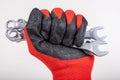 Workshop wrenches held in hand. Hand in a work glove Royalty Free Stock Photo