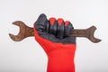 Workshop wrenches held in hand. Hand in a work glove Royalty Free Stock Photo