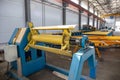 Worksop with machinery tools and equipment, conveyor line for production metal pipes and sandwich panels in factory interior