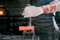 Workspace of blacksmith. Blacksmith working with red hot metal workpiece of new hammer at anvil in a forge. Making the Royalty Free Stock Photo