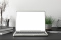 Workspace with blank laptop monitor white screen mock up on the dark desk near white wall Royalty Free Stock Photo
