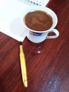 Workspace with blank notebook, fountain pen and coffee cup on the desk