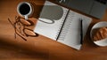 Workspace with blank notebook, pen, eyeglasses, laptop, coffee cup and snack Royalty Free Stock Photo