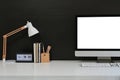 Workspace blank screen desktop computer, Mockup computer, lamp and home office accessories on white desk Royalty Free Stock Photo