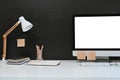 Workspace blank screen desktop computer, Mockup computer, lamp and home office accessories on white desk Royalty Free Stock Photo