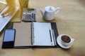 Workspace business with note book, pen smartphone,laptop computer, cup of coffee and calculator on woode table Royalty Free Stock Photo