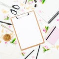 Workspace with clipboard, notebook, flowers and accessories on white background. Blog concept. Flat lay, top view Royalty Free Stock Photo