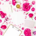 Workspace with clipboard, pastel roses and accessories on white background. Flat lay, top view Royalty Free Stock Photo