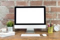 Workspace with computer with blank white screen, and office supplies on wooden desk Royalty Free Stock Photo