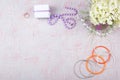 Workspace with computer, bouquet Hydrangeas, clipboard. Women`s fashion accessories isolated on pink background. Flat Royalty Free Stock Photo