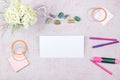 Workspace with computer, bouquet Hydrangeas, clipboard. Women`s fashion accessories on pink background. Flat Royalty Free Stock Photo