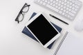 Workspace with computer keyboard, office supplies, and tablet on white background. Top view with copy space Royalty Free Stock Photo