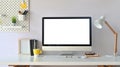 Workspace computer mockup and office supplies with peg board on wooden table.