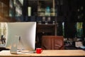 Workspace computer putting on wood working desk and surrounded by coffee cup, clipboard, potted plant, stack of smartphone, tablet Royalty Free Stock Photo