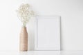 Workspace desk with empty frame and flower in vase Royalty Free Stock Photo