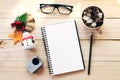 Workspace desk with notebook, pencil, pine cones in tea wooden cup, eye glasses, christmas decoration and small action camera on Royalty Free Stock Photo