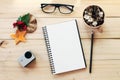 Workspace desk with notebook, pencil, pine cones in tea wooden cup, eye glasses, christmas decoration and small action camera on Royalty Free Stock Photo