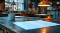 Workspace documents on a rustic table, illuminated by a bright orange lamp Royalty Free Stock Photo