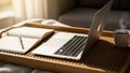 Workspace features an open silver laptop on a wicker tray next to an Royalty Free Stock Photo