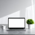 Workspace Featuring Laptop Computer With White Screen And Potted Plant on Concrete Desk in Front of White Royalty Free Stock Photo