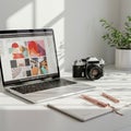 A workspace featuring a laptop displaying abstract art designs on its screen. Next to Royalty Free Stock Photo
