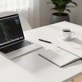 Workspace featuring a sleek laptop displaying code suggesting a Royalty Free Stock Photo