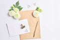 workspace female. flowers dahlias on a white background. gold writing materials and notepad made kraft paper. Royalty Free Stock Photo