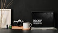 Workspace with laptop, coffee mug, camera, supplies and mock up frame, clipping path