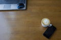 Workspace with laptop, a cup of coffee and a mouse for a laptop, phone, glasses on a white wooden table Royalty Free Stock Photo