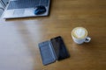 Workspace with laptop, a cup of coffee and a mouse for a laptop, phone, glasses on a white wooden table Royalty Free Stock Photo