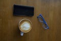 Workspace with laptop, a cup of coffee and a mouse for a laptop, phone, glasses on a white wooden table Royalty Free Stock Photo