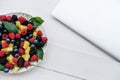 Workspace with laptop and healthy berries in rainbow colours, pi Royalty Free Stock Photo