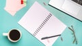 Workspace. Laptop, notebook with empy blank for text on a blue table background