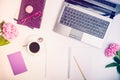 Workspace with laptop, notebook, sketchbook, glasses, cup of coffee and wisteria flowers on white background. Top view feminine of