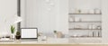 Workspace with laptop mockup on a white marble tabletop in luxury white living room Royalty Free Stock Photo