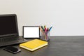 Workspace with laptop, yellow diary, photo frame, color pensils
