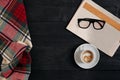 Workspace with newspaper, coffee cup, scarf, glasses. Stylish office desk. Autumn or Winter concept. Flat lay, top view Royalty Free Stock Photo
