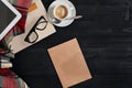 Workspace with newspaper, coffee cup, scarf, glasses. Stylish office desk. Autumn or Winter concept. Flat lay, top view Royalty Free Stock Photo