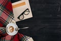 Workspace with newspaper, coffee cup, scarf, glasses. Stylish office desk. Autumn or Winter concept. Flat lay, top view Royalty Free Stock Photo