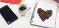 Workspace with notebook, office supplies, eyeglasses, smartphone and coffee cup. Office desk with cup of coffee. Coffee beans on p Royalty Free Stock Photo