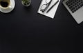 Workspace in office with black table. Top view from above of laptop with notepad and coffee. Desk for modern creative work of desi Royalty Free Stock Photo