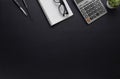 Workspace in office with black table. Top view from above of notebook with pen and glasses. Desk for modern creative work of desig Royalty Free Stock Photo