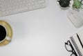 Workspace office with a white desk. Top view from above with keyboard, notebook and pencil with a white cup coffee on the wooden p Royalty Free Stock Photo